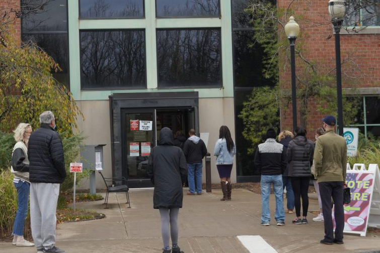 Voters wait outside of the early polling station in Dewitt, N.Y. on Oct. 31.