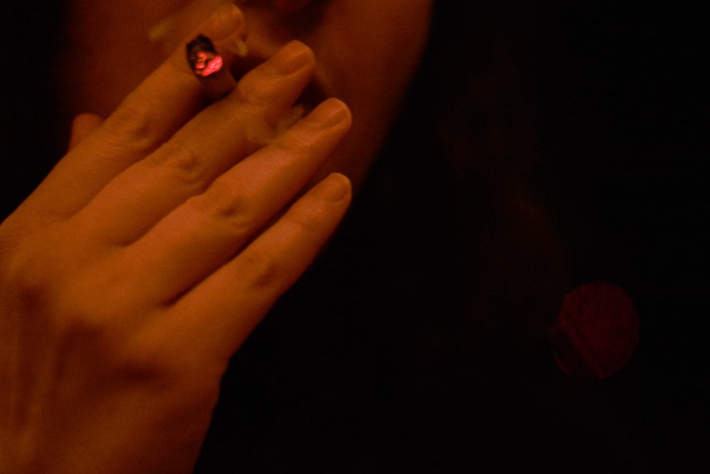 A Syracuse University student smokes while in quarantine.