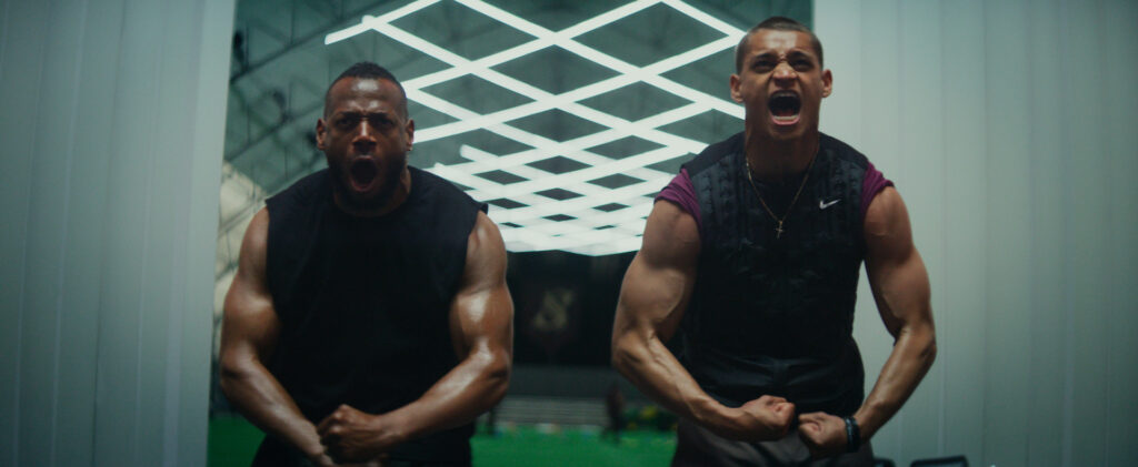 two men standing next to each other, screaming and flexing their muscles