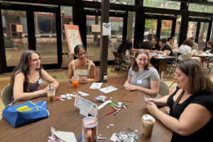 Students talk at a table