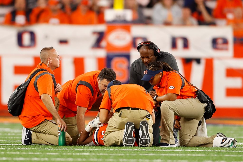 SYRACUSE, NY - OCTOBER 1: Head coach Dino Babers of Syracuse Orange and the athletic training staff surround Sean Tucker #34 of Syracuse Orange at JMA Wireless Dome on October 1, 2022 in Syracuse, New York. (Photo by Isaiah Vazquez)