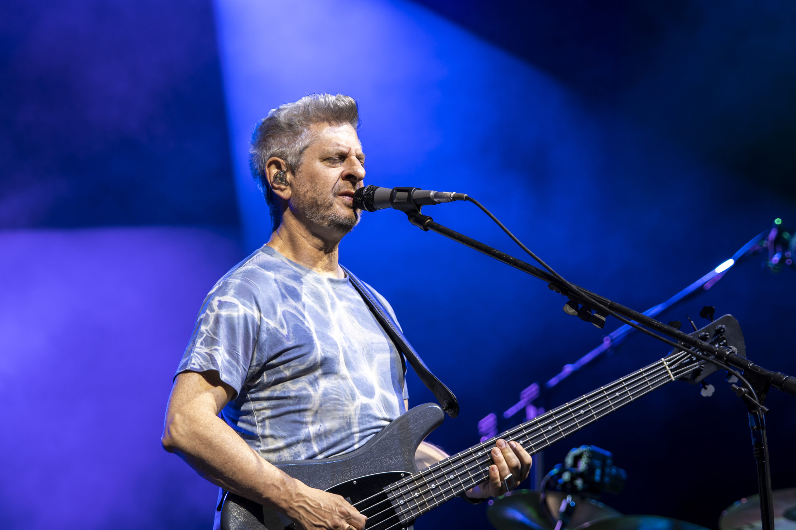 Mike Gordon sings and plays bass during Phish’s performance at Empower Federal Credit Union Amphitheater at Lakeview in Syracuse, N.Y., on Tuesday, July 21, 2026. In addition to his work with Phish, Gordon leads his own band and has explored styles ranging from funk and psychedelic folk to dancehall and experimental rock in his solo music. Photo by Matt Hofmann