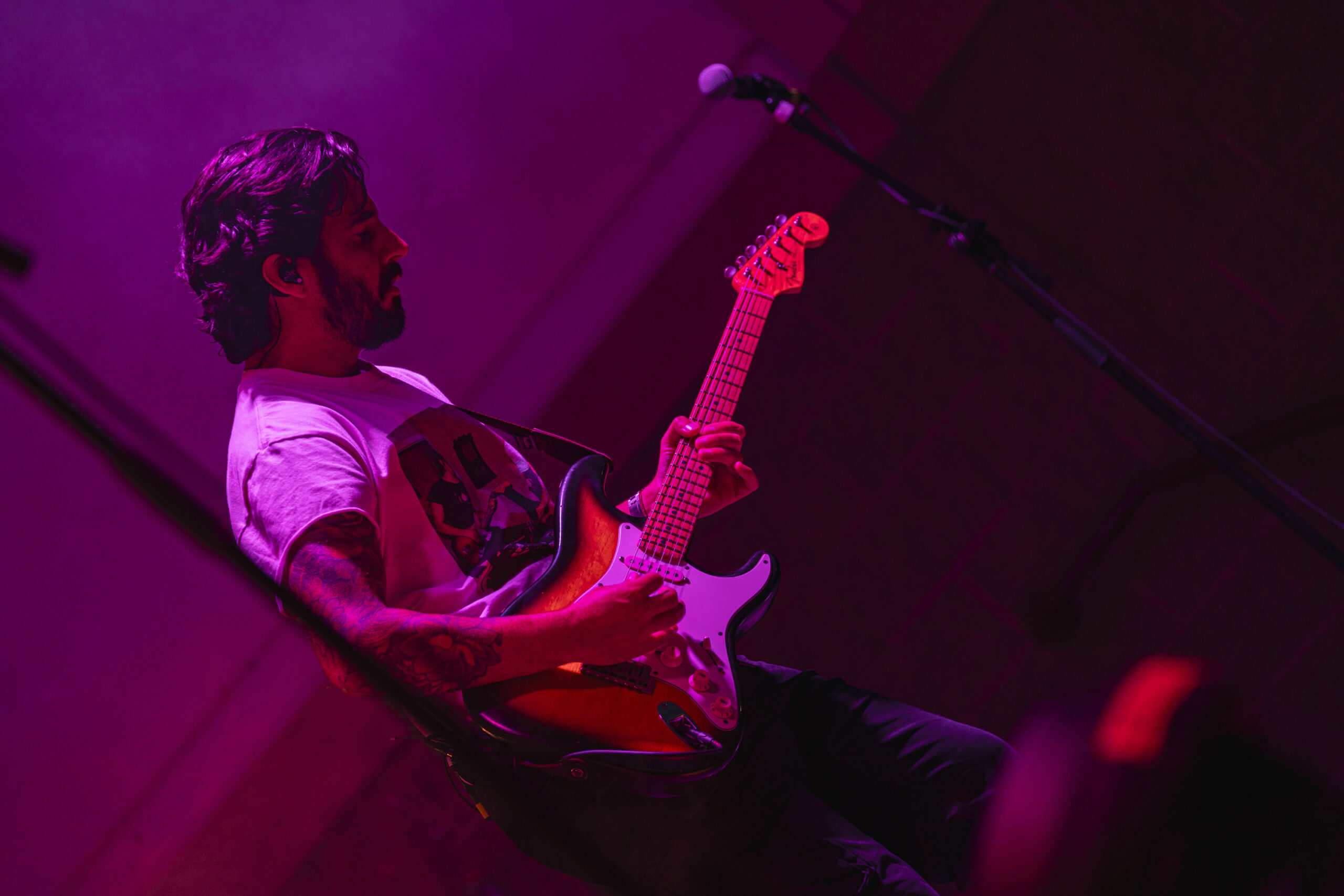Jon Becker of Ripe leans into the band’s funk-driven sound beneath purple stage lights during the headlining set at Paper Mill Island in Baldwinsville on Friday, Aug. 14, 2026. Becker’s performance helped carry the high-energy set as the crowd packed in around the stage. Photo by Matt Hofmann.