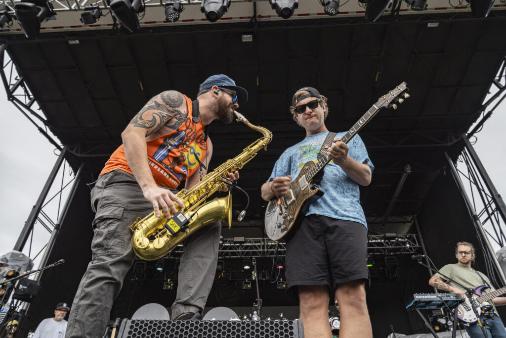 Bumpin Uglies frontman Brandon Hardesty, left, performs alongside saxophonist Will Lopez during the band’s opening set at Beak & Skiff Apple Orchards on Sunday. The Annapolis, Maryland, group kicked off the evening ahead of DENM and Slightly Stoopid. Photo by Matt Hofmann.