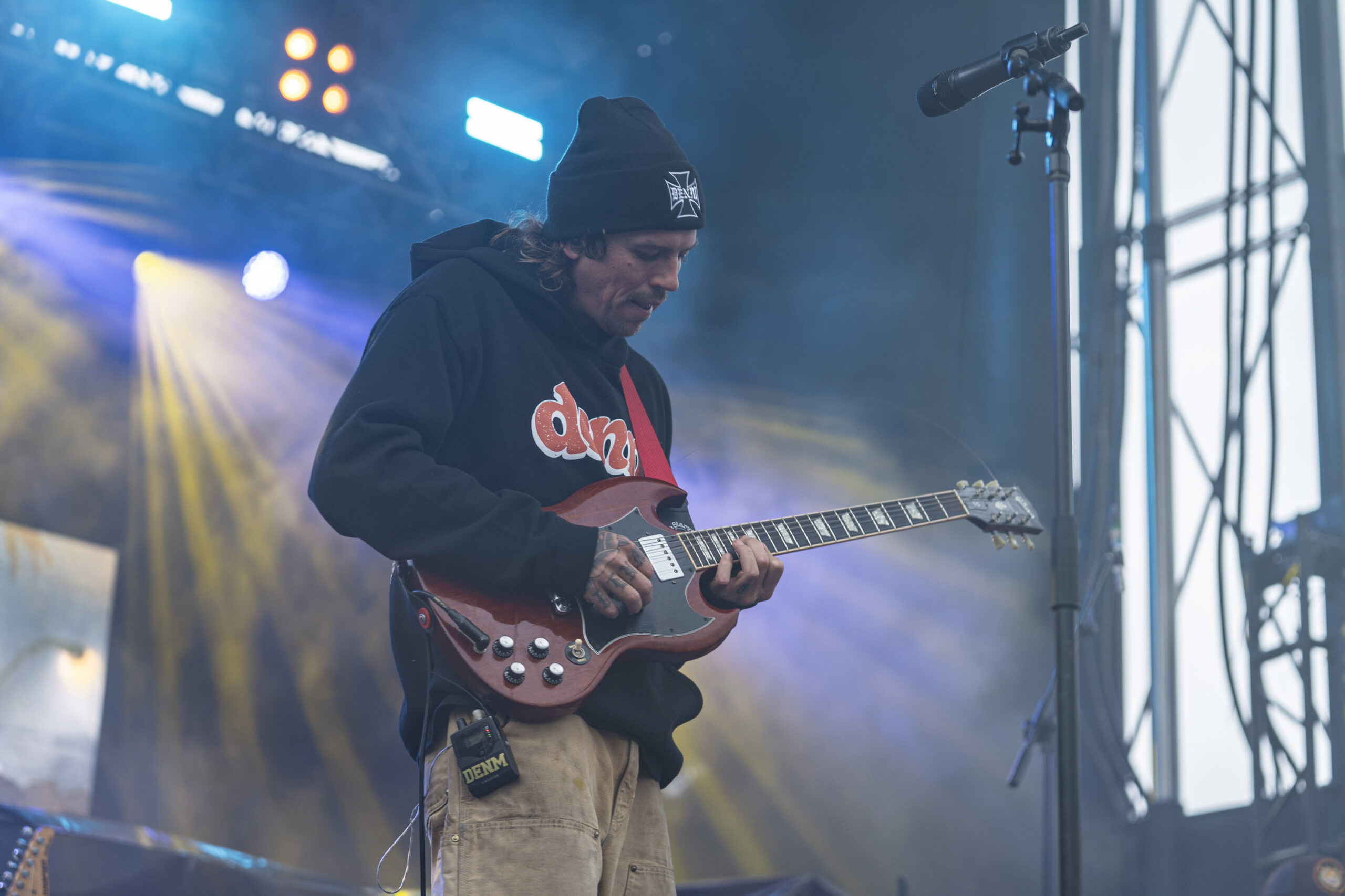 Mac Montgomery plays guitar during DENM’s performance at Beak & Skiff Apple Orchards on Sunday. Montgomery’s beach-town sound and Southern California roots made DENM a natural fit alongside Slightly Stoopid. Photo by Matt Hofmann.