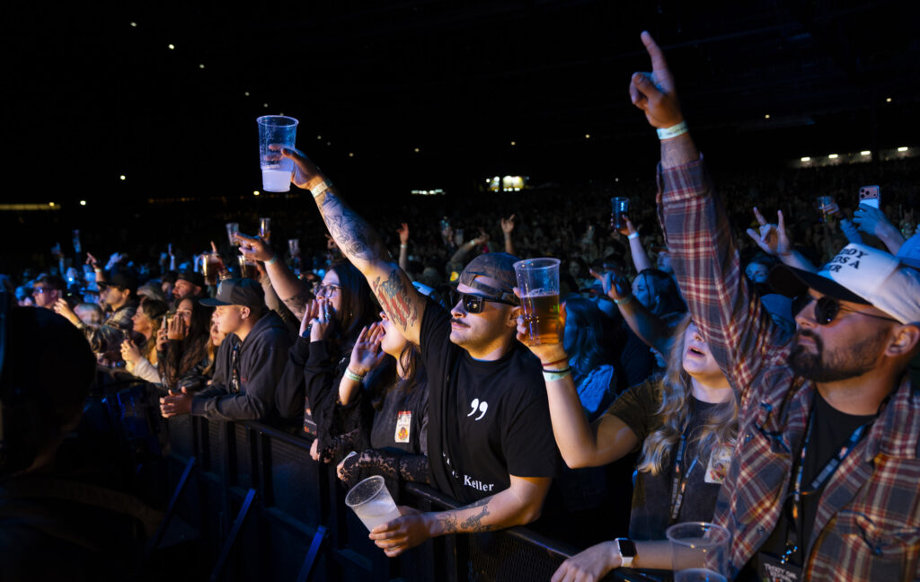 Fans raise their drinks from the pit during Treaty Oak Revival’s performance at Empower Federal Credit Union Amphitheater at Lakeview in Syracuse, N.Y., on Thursday, Sept. 24, 2026. Photo by Matt Hofmann.