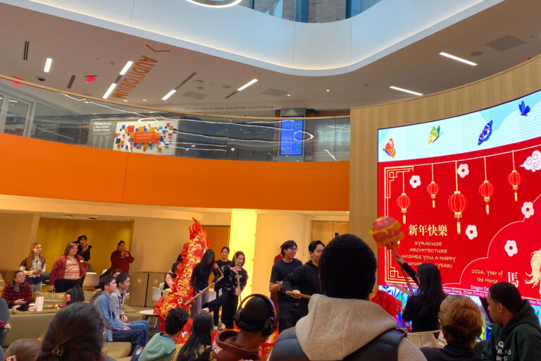 An open auditorium with students watching a cultural performance.