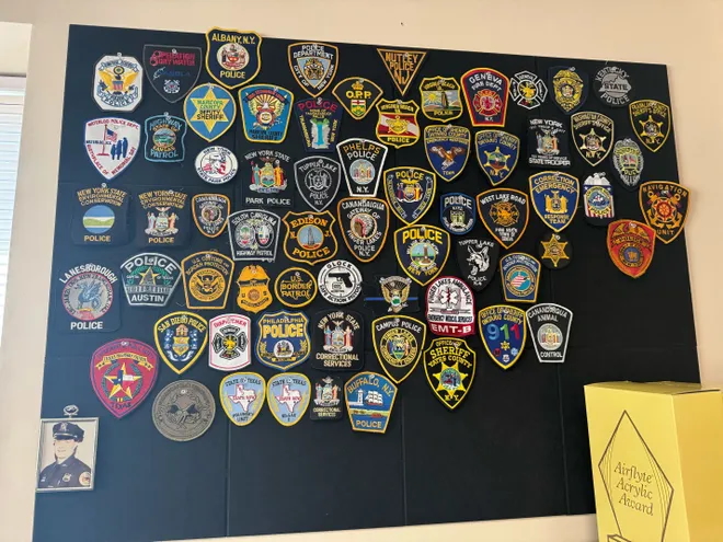 A bulletin board, filled with logos from various police departments, on display at the Geneva Police Department.