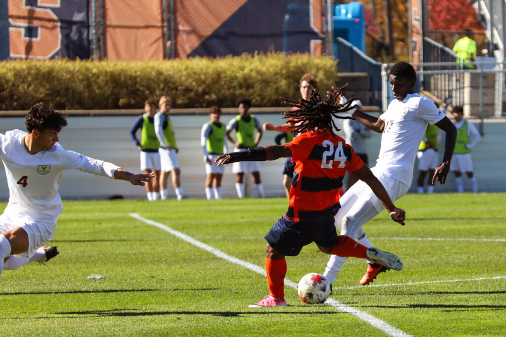 Syracuse forward Sachiel Ming takes a shot at the goal as he is guarded by two Virginia defenders during the Syracuse-Virginia men's soccer game on October 24, 2026, at SU Soccer Stadium.