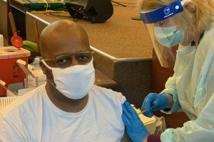 Pastor Daren Jaime of People’s AME Zion Church on Syracuse’s South Side receives his first dose of the COVID-19 vaccine at the church’s vaccination site on January 25, 2021.