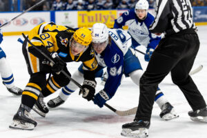 Syracuse Crunch forward Connor Geekie and Wilkes Barre/Scranton Penguins foward Atley Calvert face off for the puck during their game on Saturday, January 3rd, 2025, at the Upstate Medical University Arena.