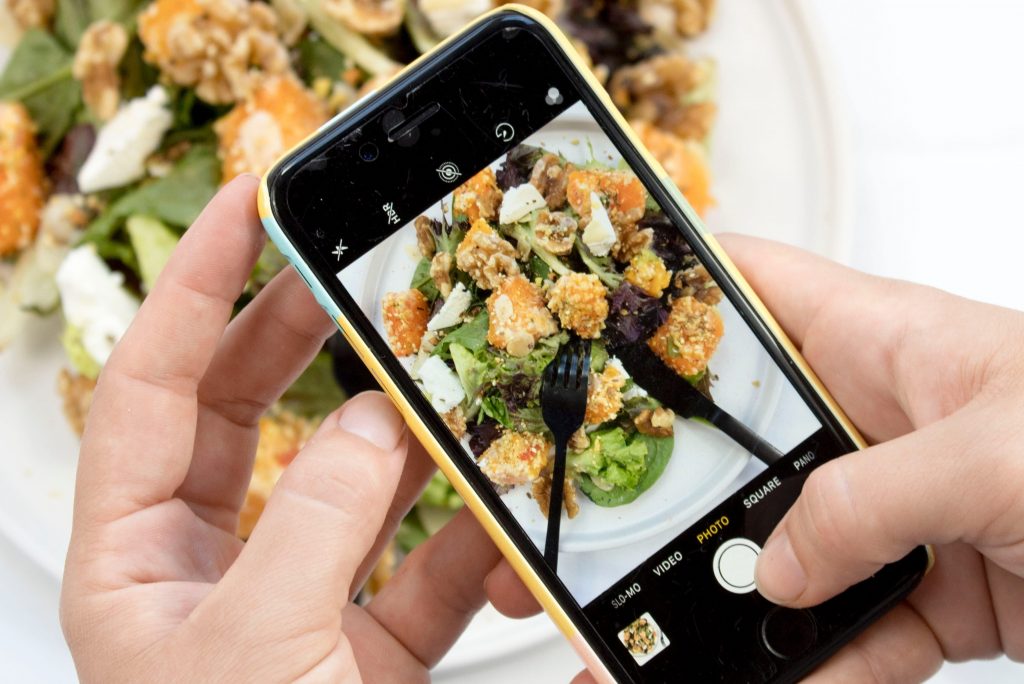 Person taking photo of their food.
