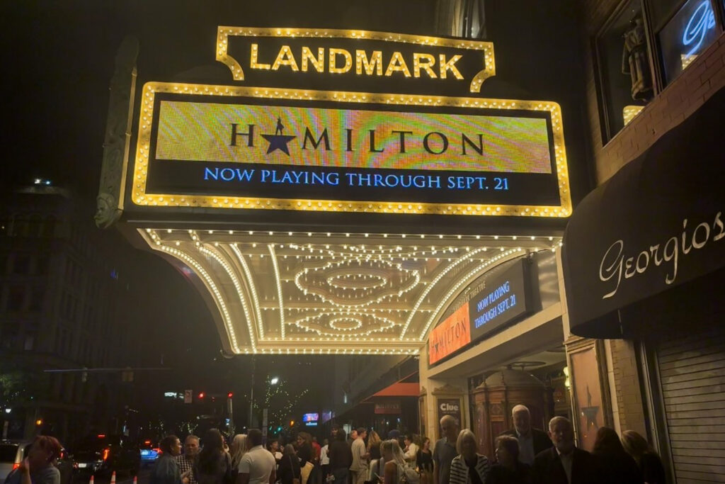 Picture of outside the Landmark Theater in Syracuse with Hamilton displayed on the entrance screen